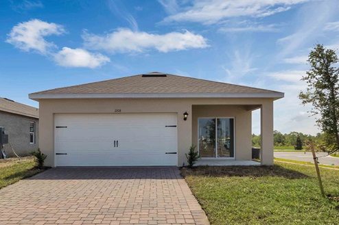 Single story new home with siding, covered porch and 2 car garage.