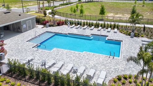 Sunny day at the community swimming pool with lounge seating.
