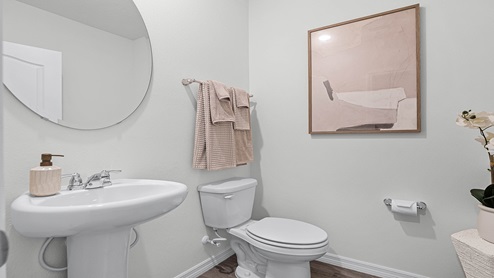 Guest half bathroom with single vanity and toilet.