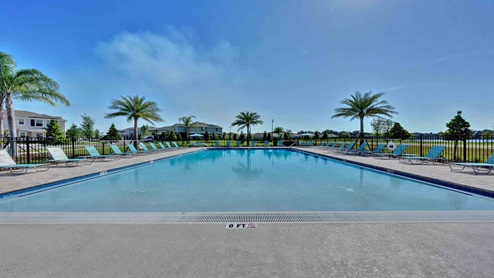 Sunny day at the community swimming pool with lounge seating.