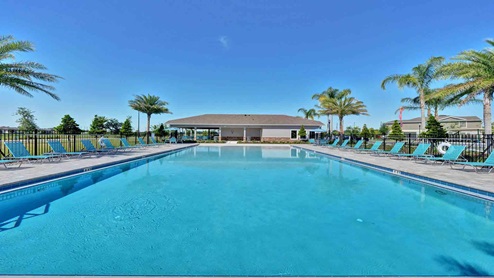 Sunny day at the community swimming pool with lounge seating.