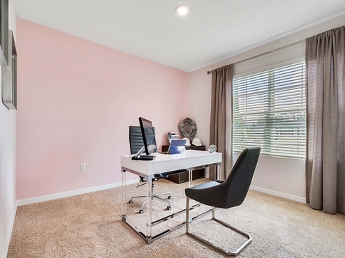 Functional home office with desk, chairs and space to work or play.