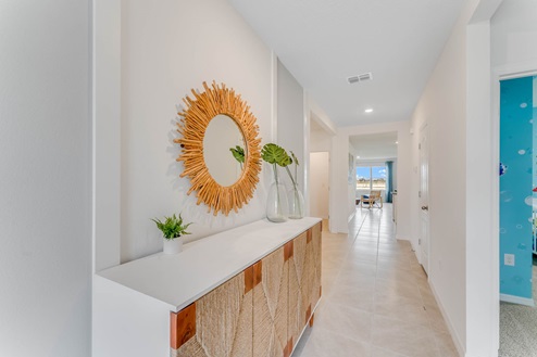 Home entry way thru the front door with tile flooring and a view to the living space.