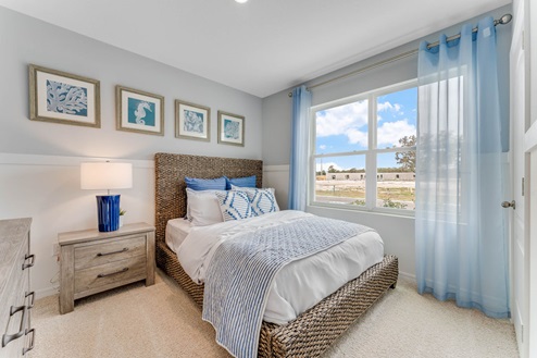 Guest bedroom with bed, nightstands and a roomy closet for storage.
