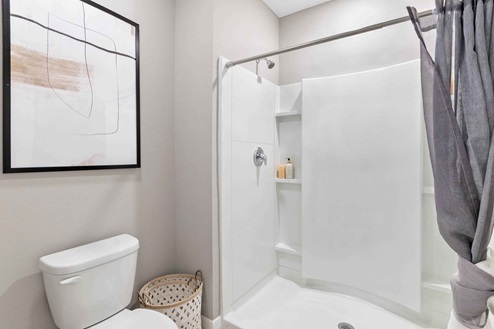 Private lavatory and modern walk-in shower.