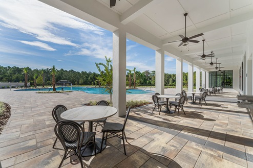 Sunny day at the community swimming pool with lounge seating.