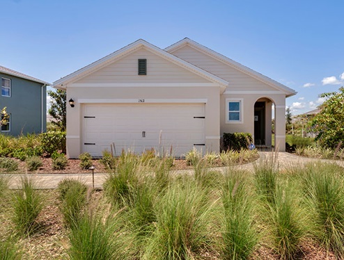 Single story new home with siding, covered porch and 2 car garage.