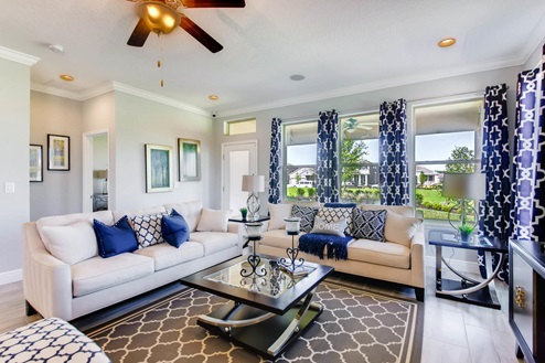 Living area with with couch seating with access to the backyard.