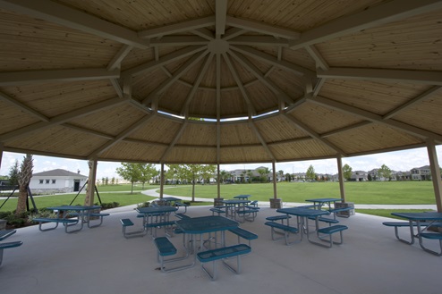 Covered sitting area amenity overseeing land.