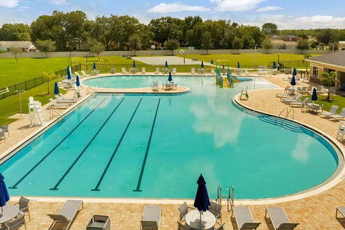 Sunny day at the community swimming pool with lounge seating.