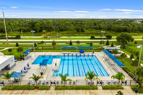 Sunny day at the community swimming pool with lounge seating.