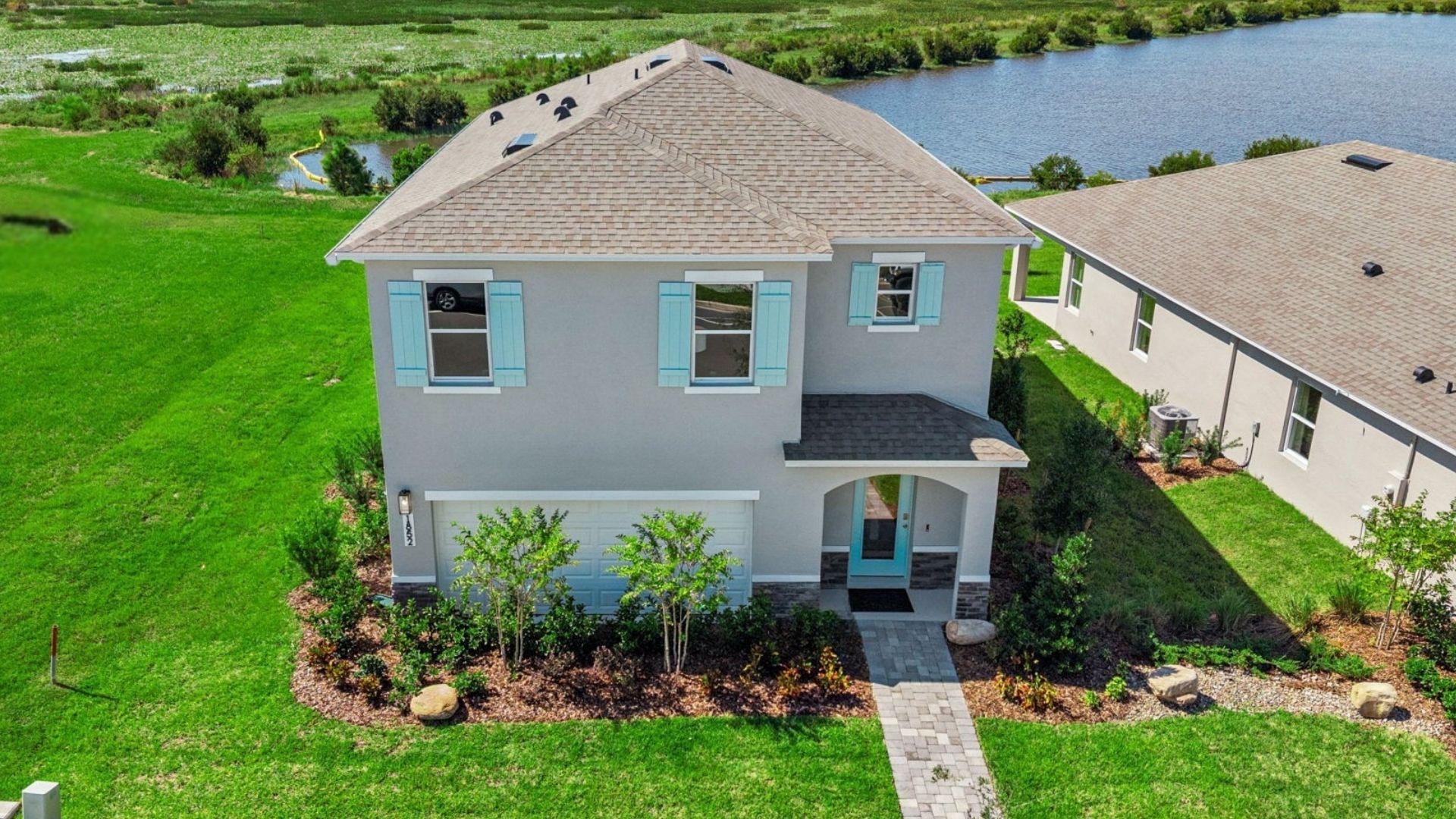 Single story new home with large windows and 2 car garage.