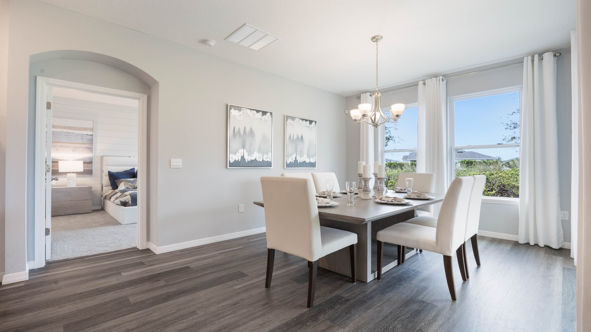 Dining room area with table, seating and natural lighting.