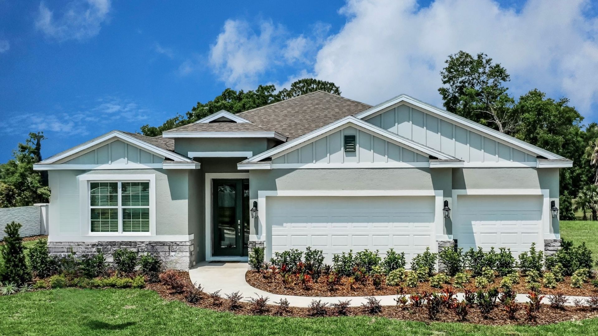 Single story new home with large windows and 2 car garage.
