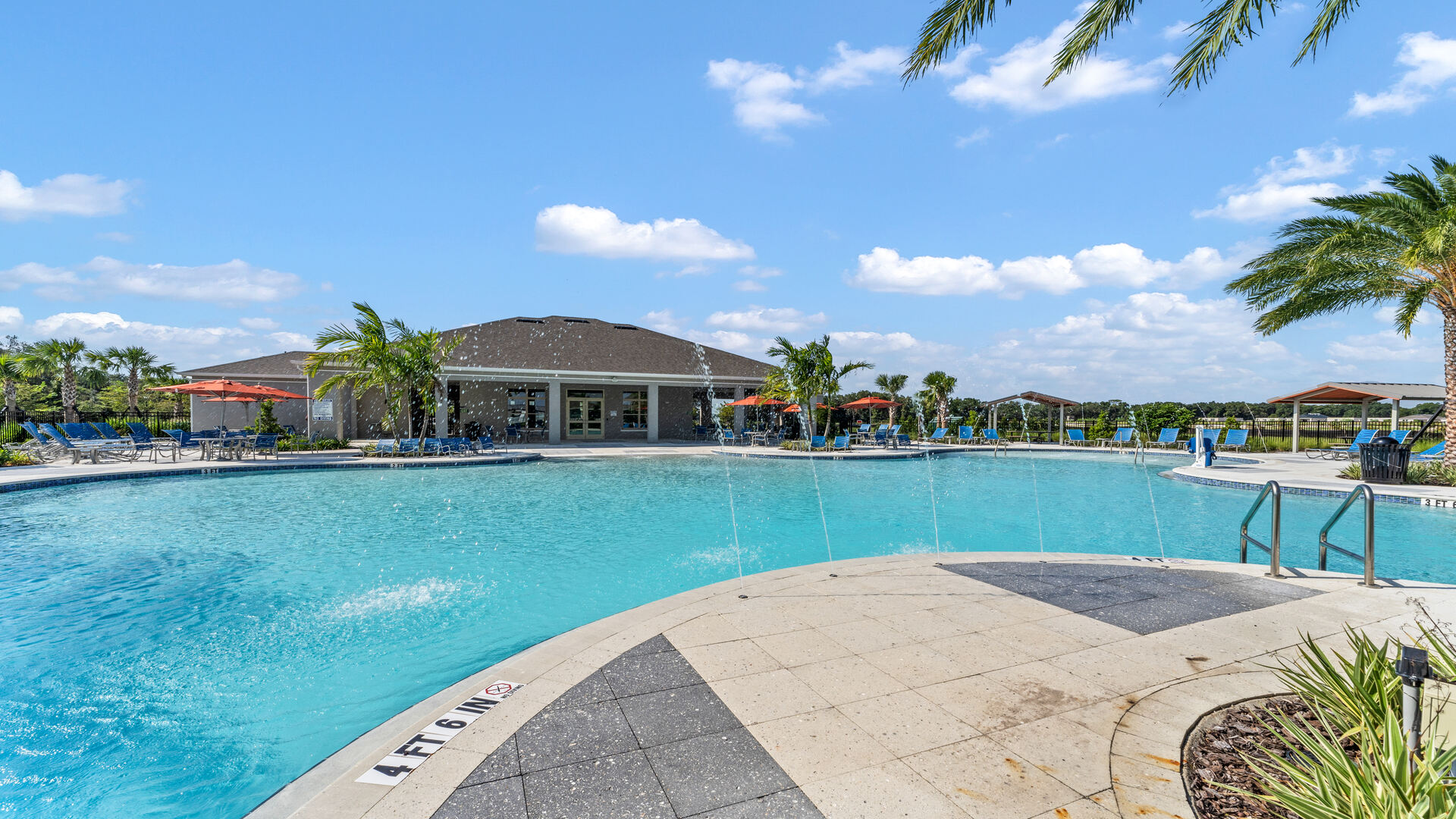 Sunny day at the community swimming pool with lounge seating.