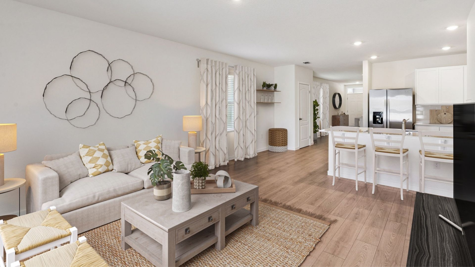 Open concept living area with couch seating overseeing kitchen