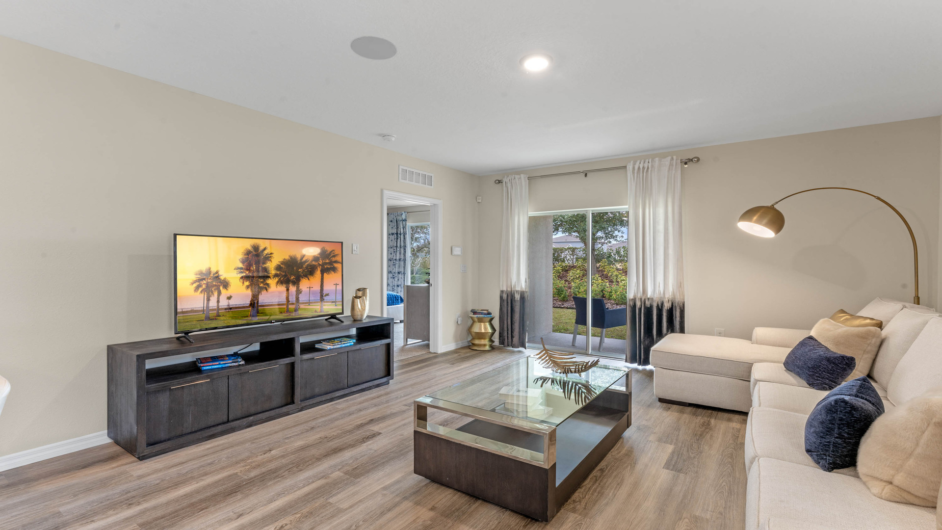 Open concept living area with couch seating and backyard access.