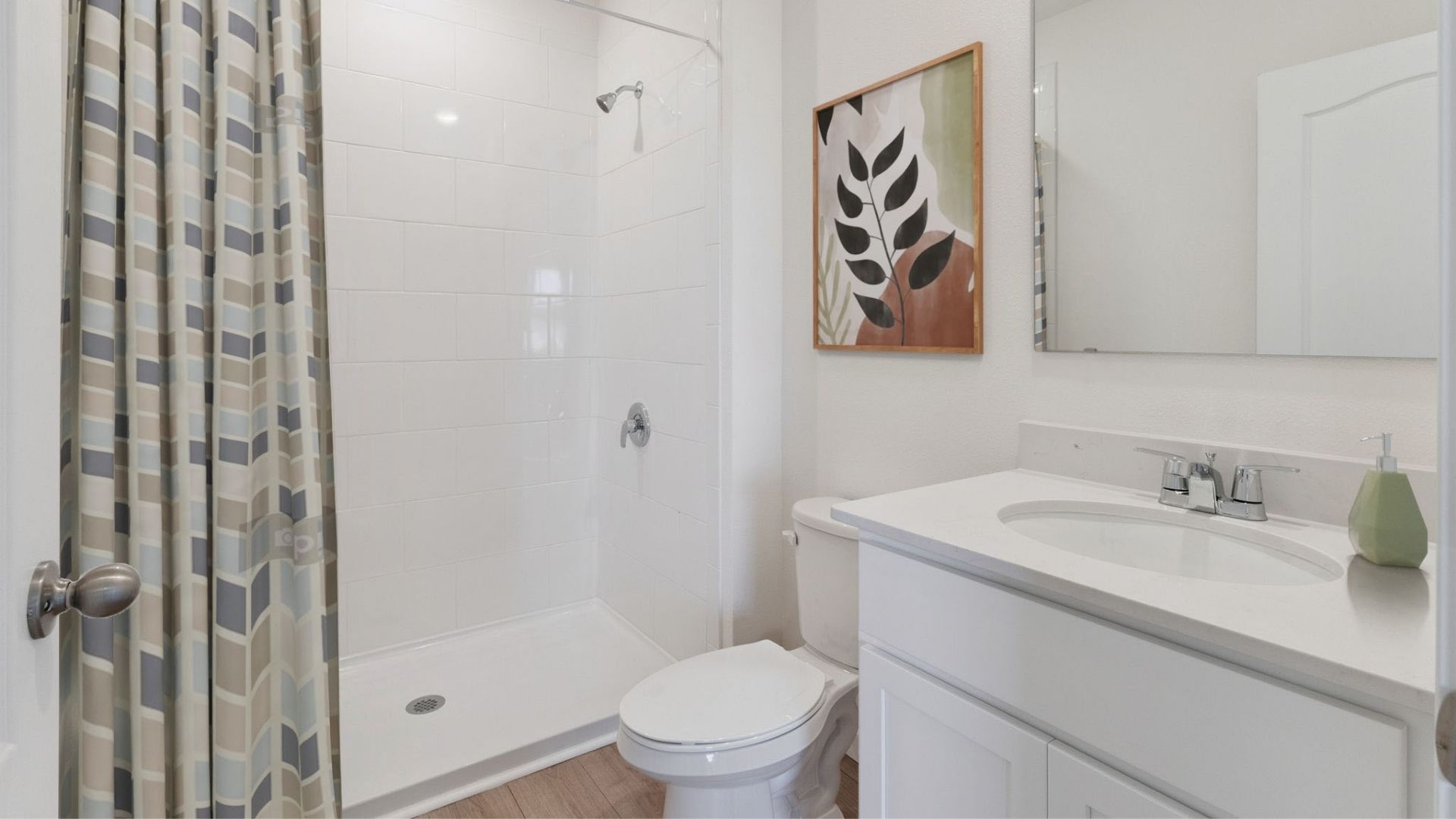 Modern bathroom with single vanity, large wall mirror, cabinets and quartz countertops