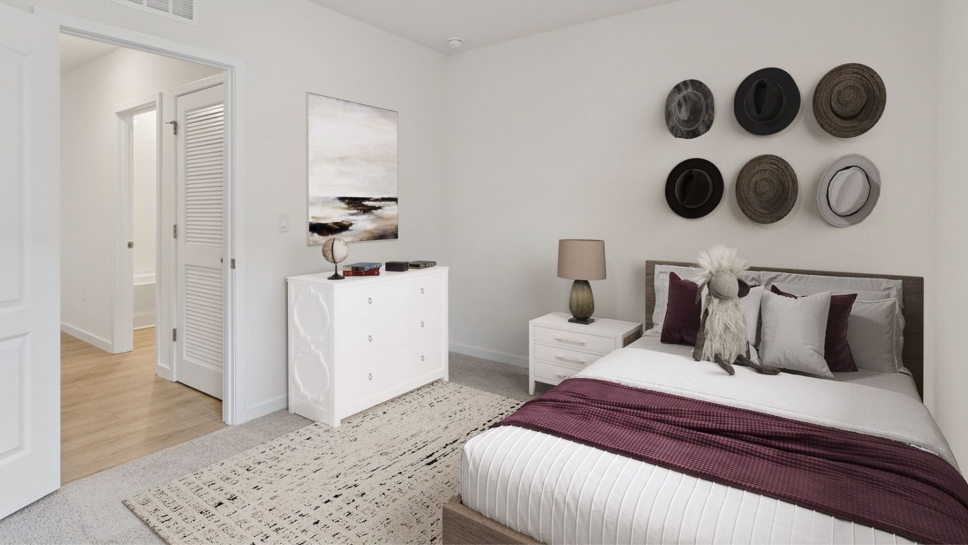 Guest bedroom with bed, nighstands and natural lighting.
