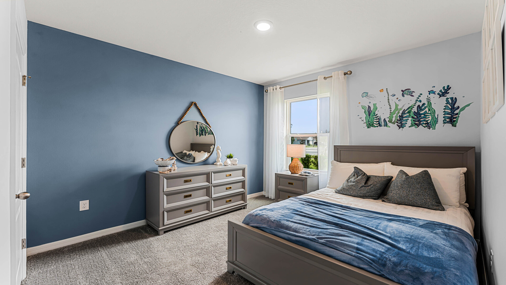 Guest bedroom with bed, nighstands and natural lighting.