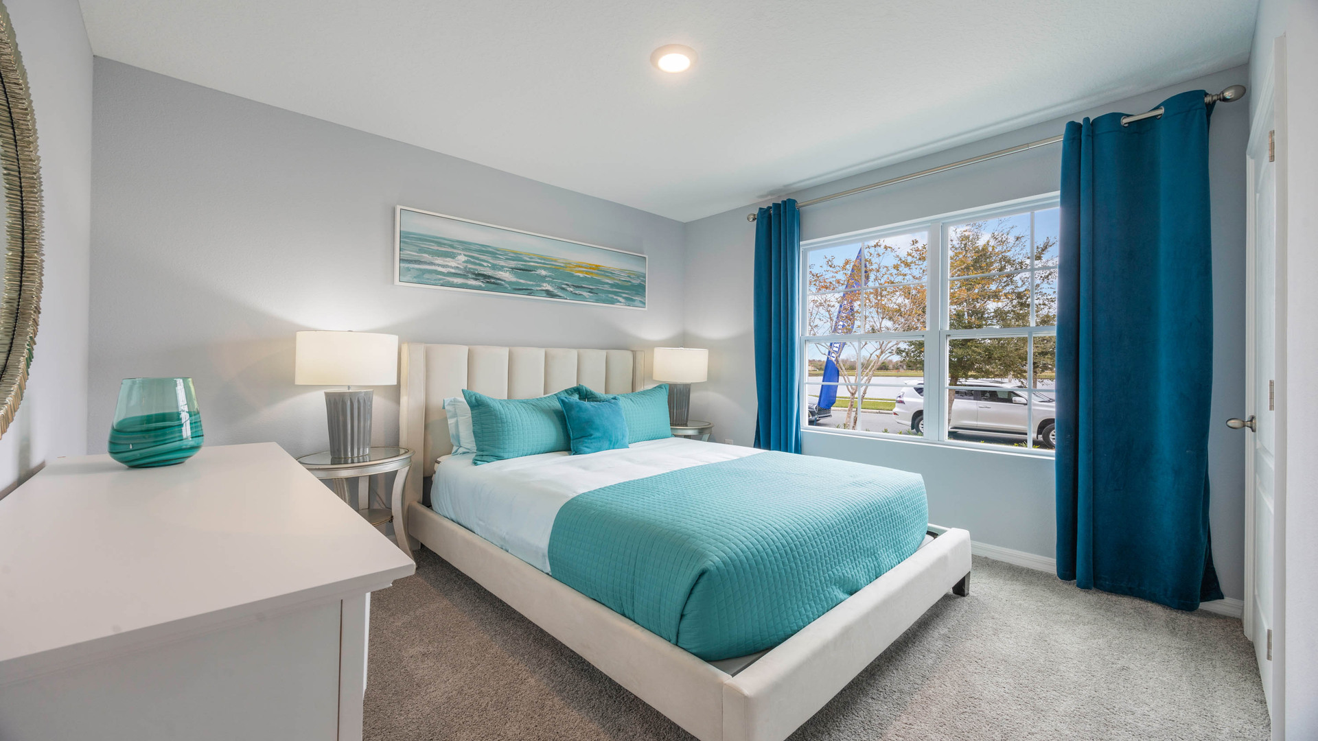 Guest bedroom with bed, nighstands and natural lighting.