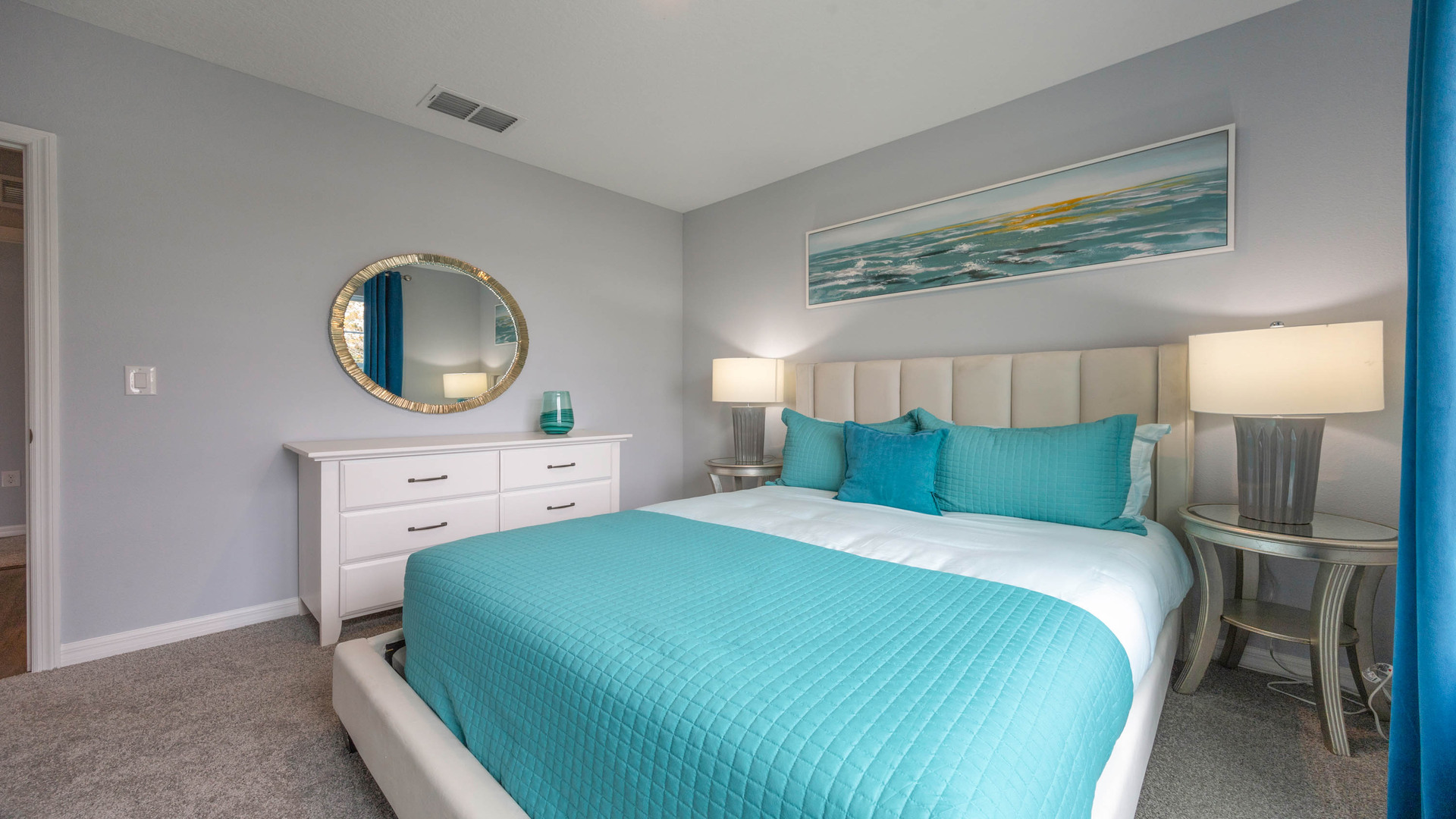 Guest bedroom with bed, nighstands and natural lighting.