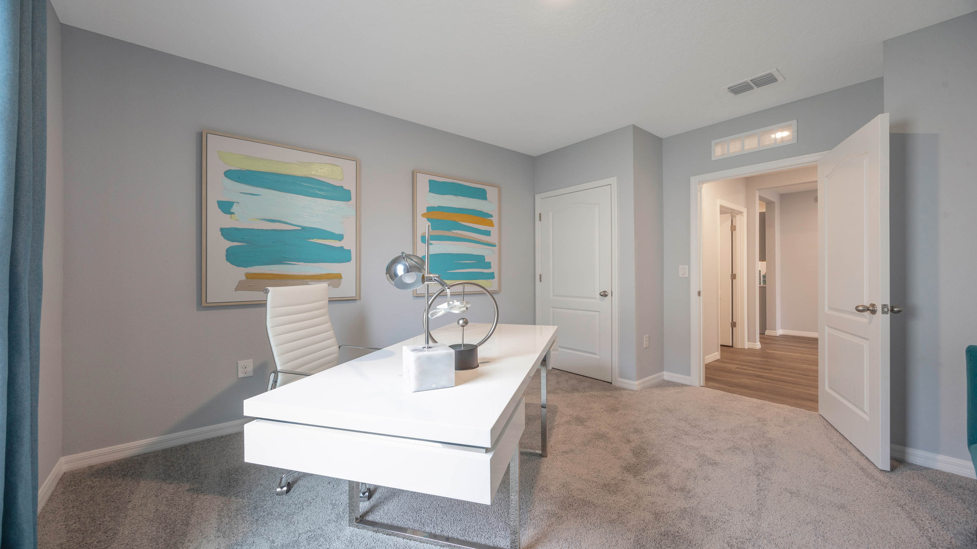 Functional home office with desk, chairs and space to work or play.