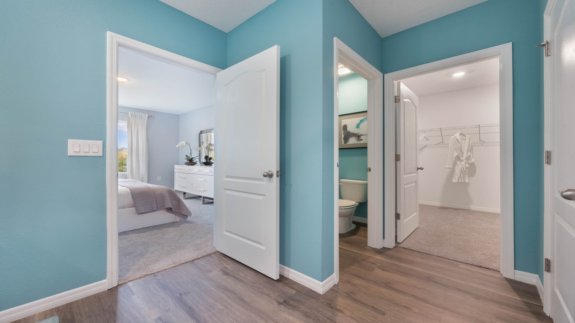 Modern bathroom with double vanity, large wall mirror, cabinets and quartz countertops along with walk-in shower