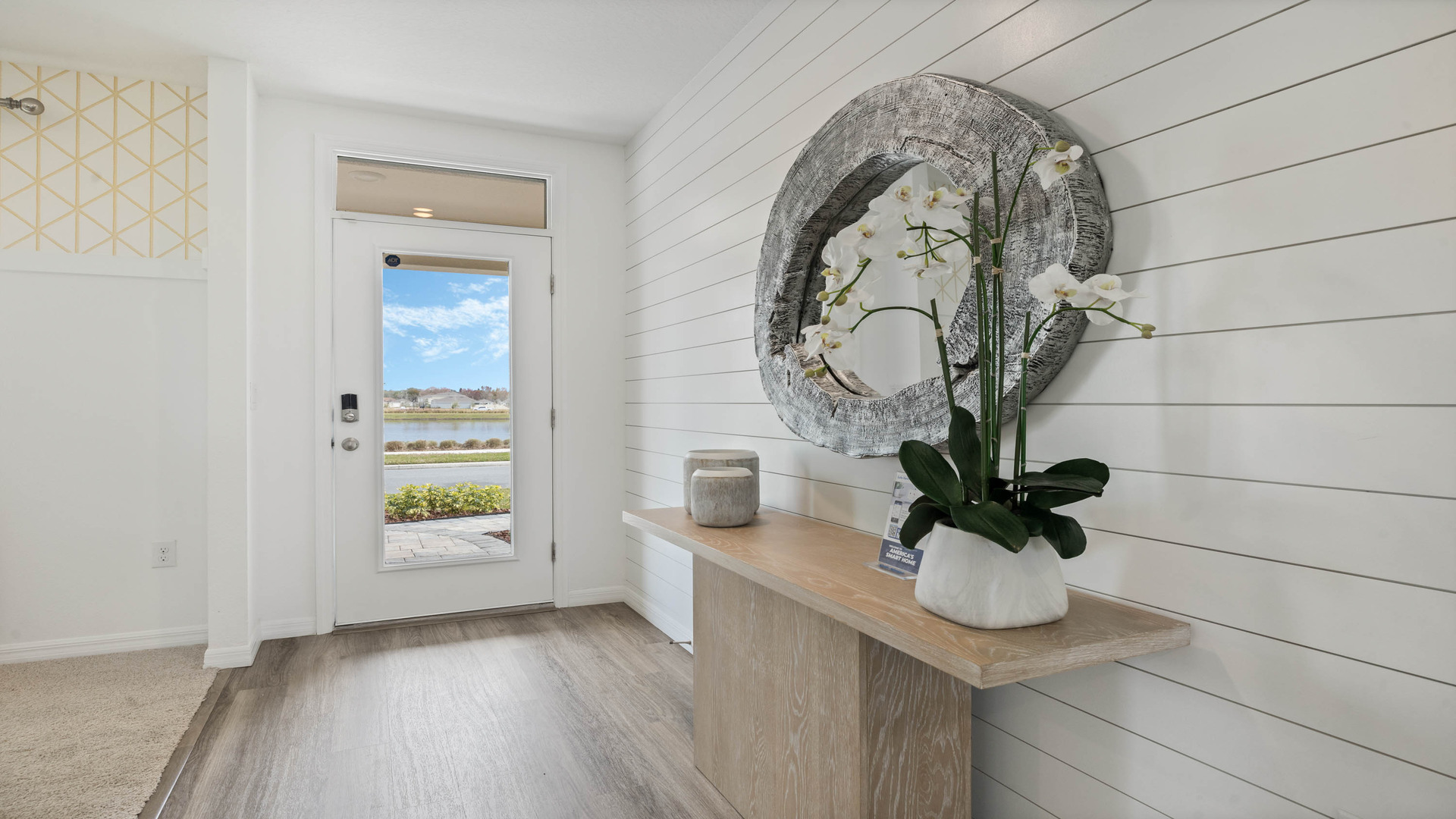 Entry to home showing front door with luxury vinyl plank flooring.