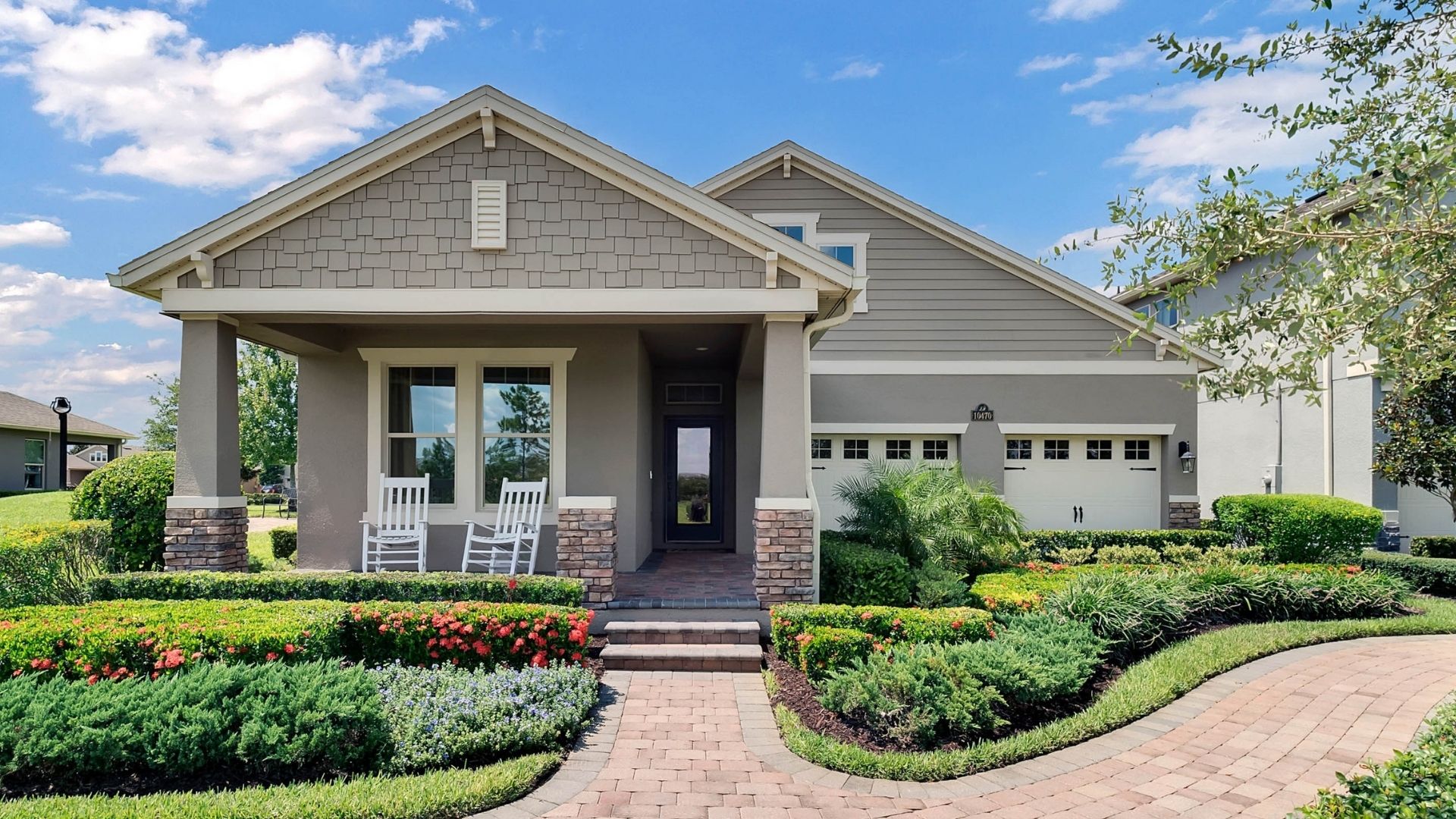 Single story new home with large windows and 2 car garage.
