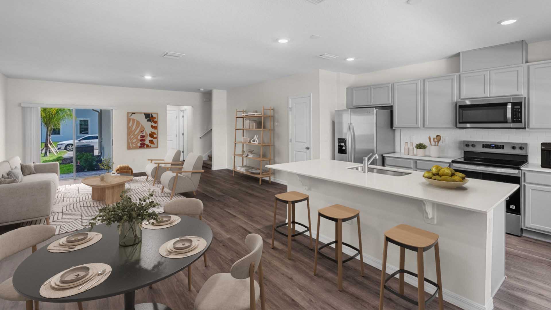 kitchen with quartz countertops overseeing living area and dining room table
