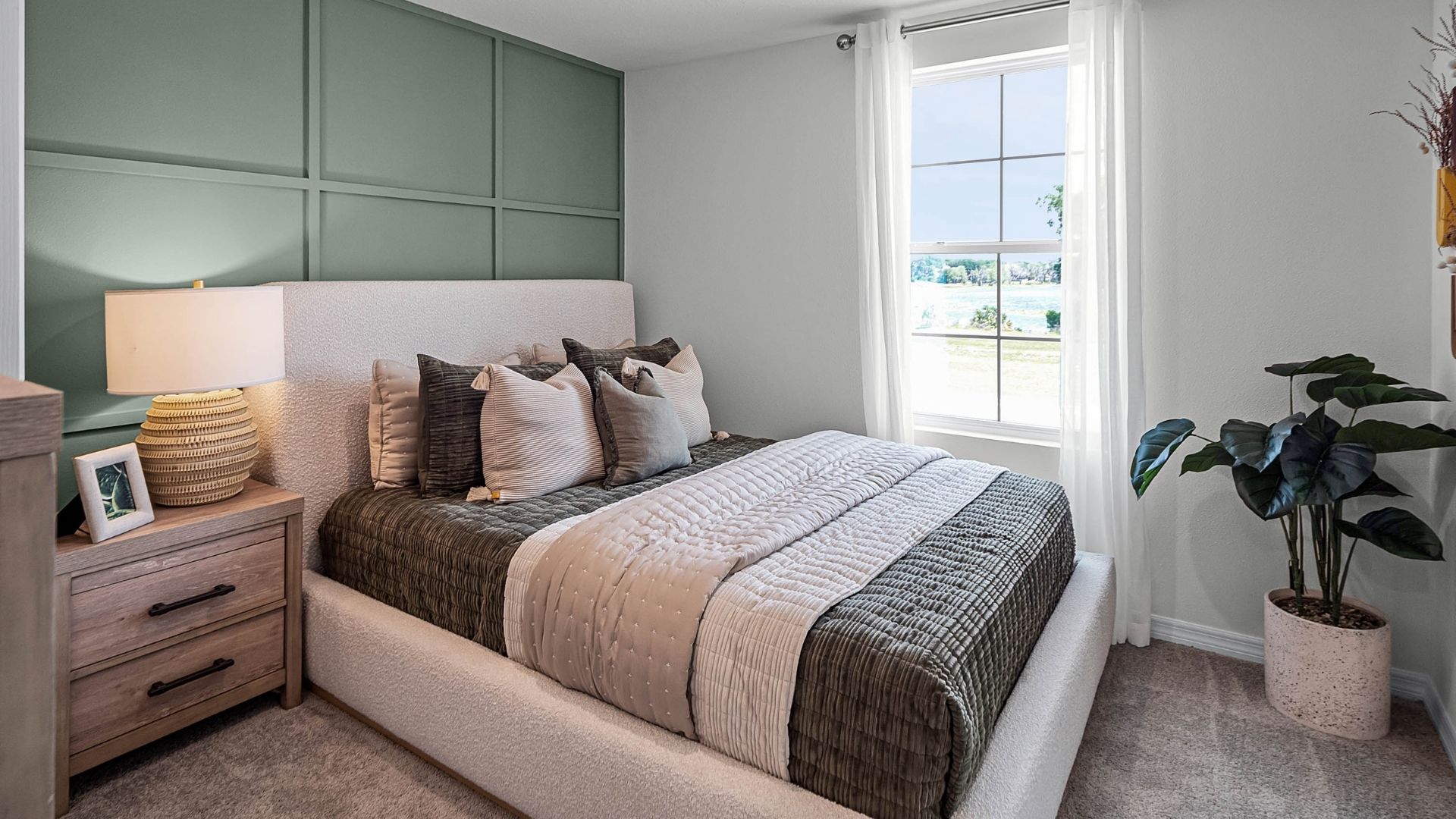 guest bedroom with bed and natural lighting
