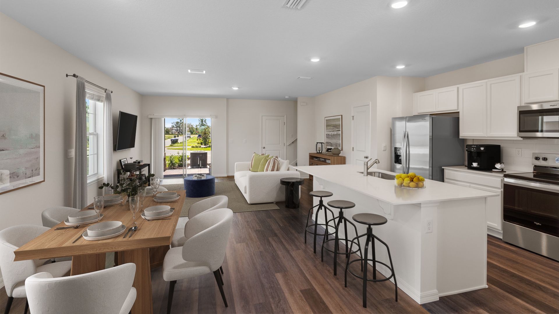 kitchen with quartz countertops overseeing living area and dining room table