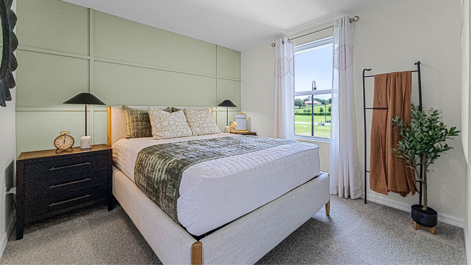 guest bedroom with queen bed and carpet flooring