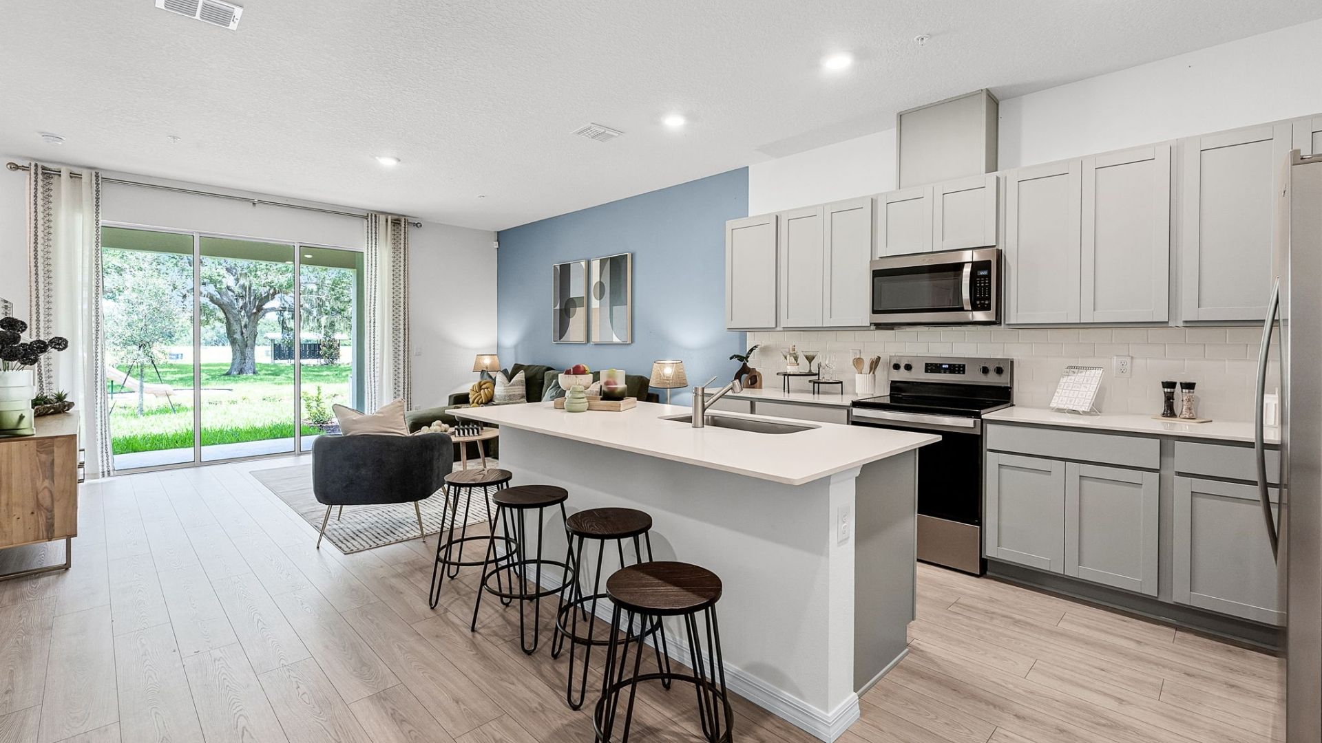 kitchen with quartz countertops overseeing living area and dining room table