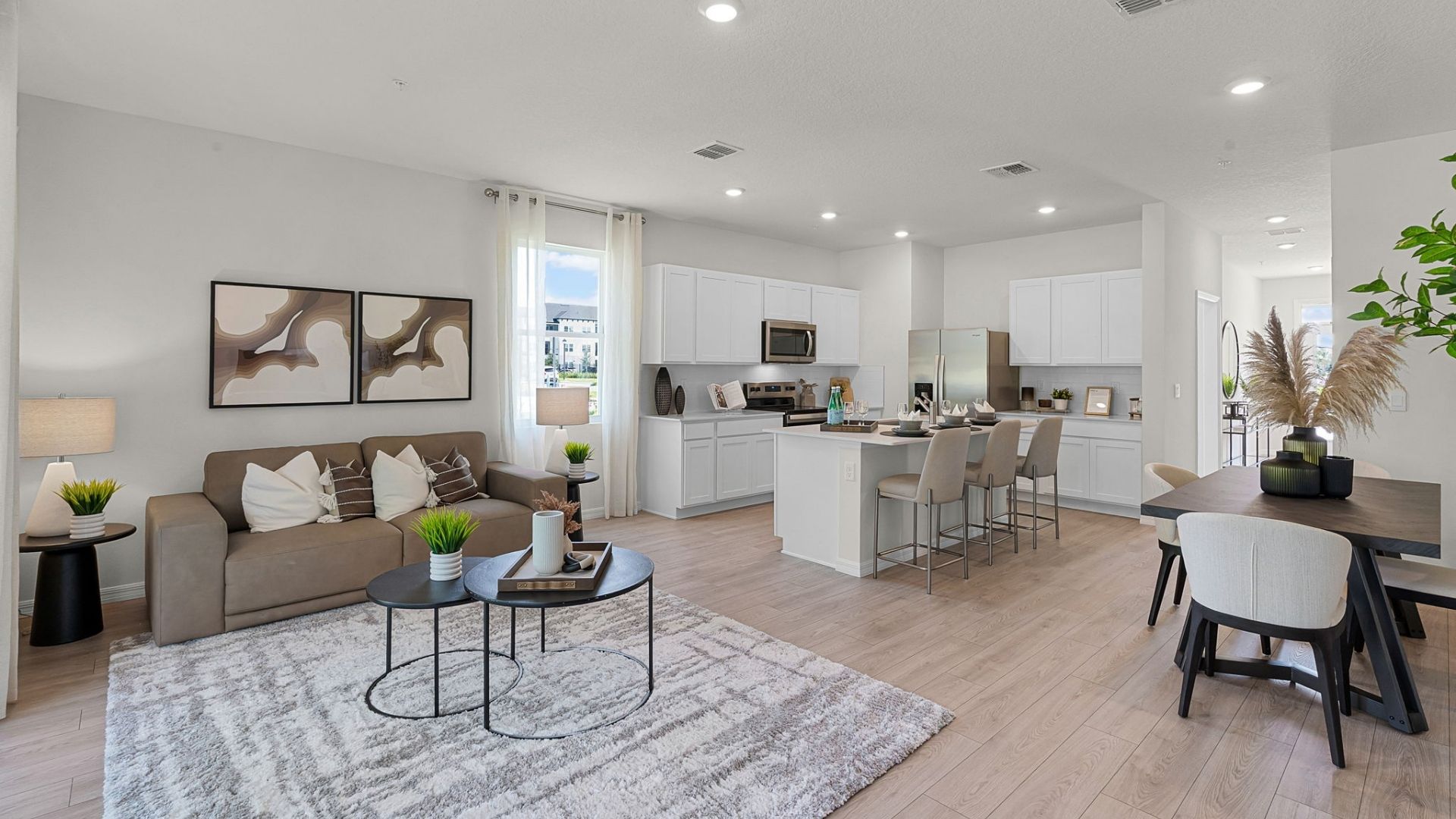 kitchen with quartz countertops overseeing living area and dining room table