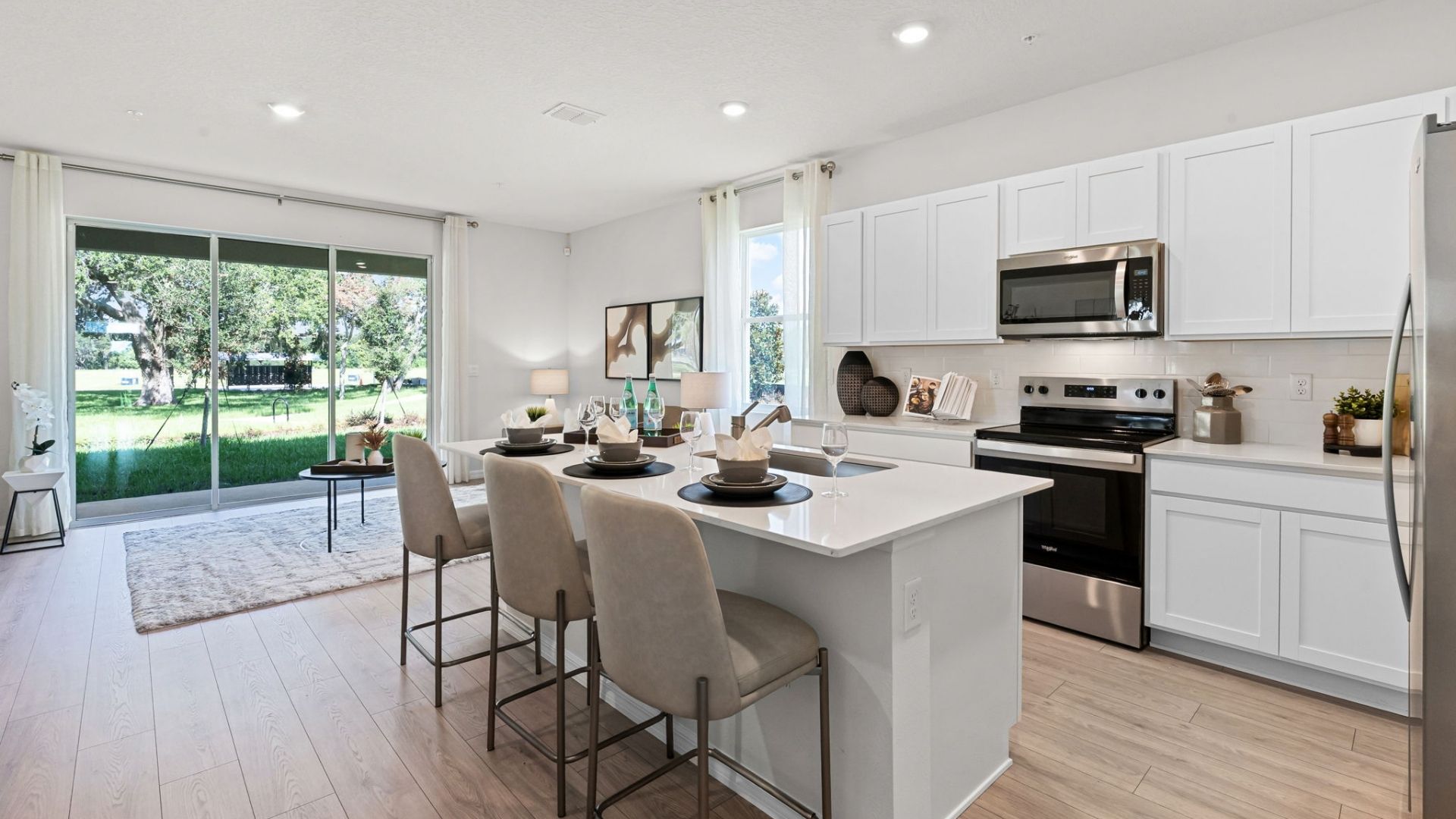 kitchen with quartz countertops overseeing living area and dining room table