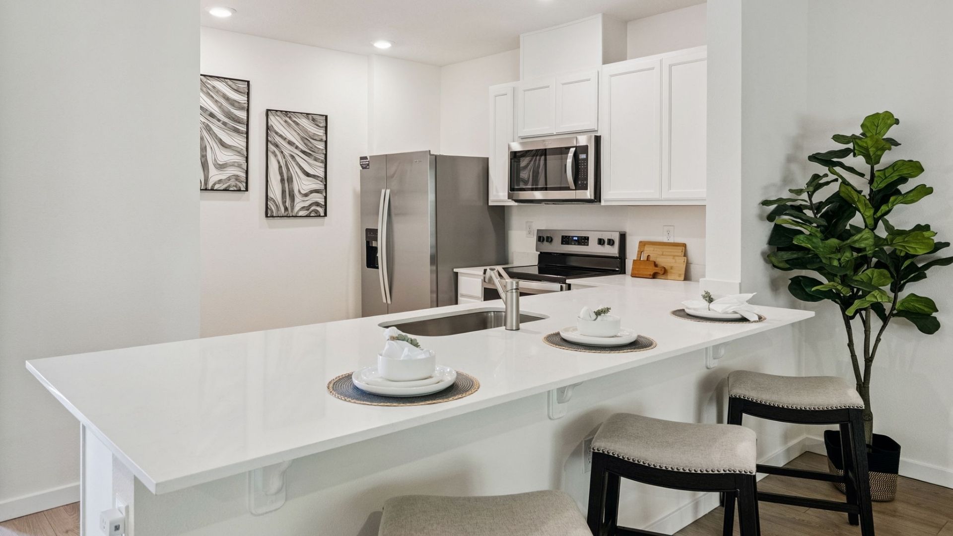 kitchen with quartz countertops overseeing living area and dining room table