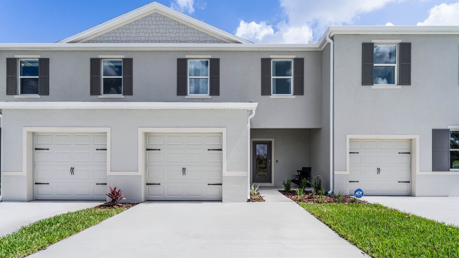 Attached townhome with concrete block construction and a one-car garage.