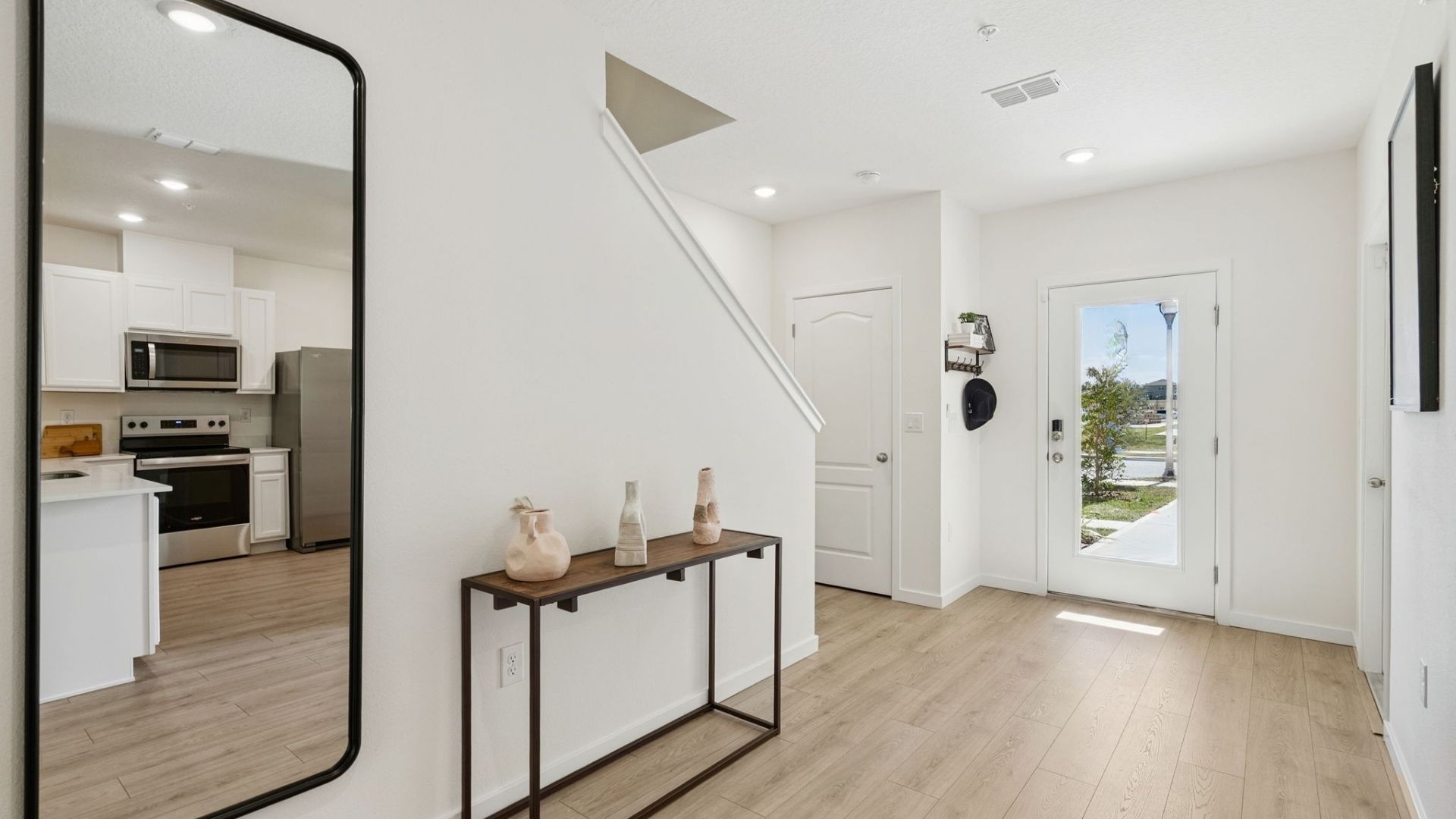 entry way to home with laminate flooring