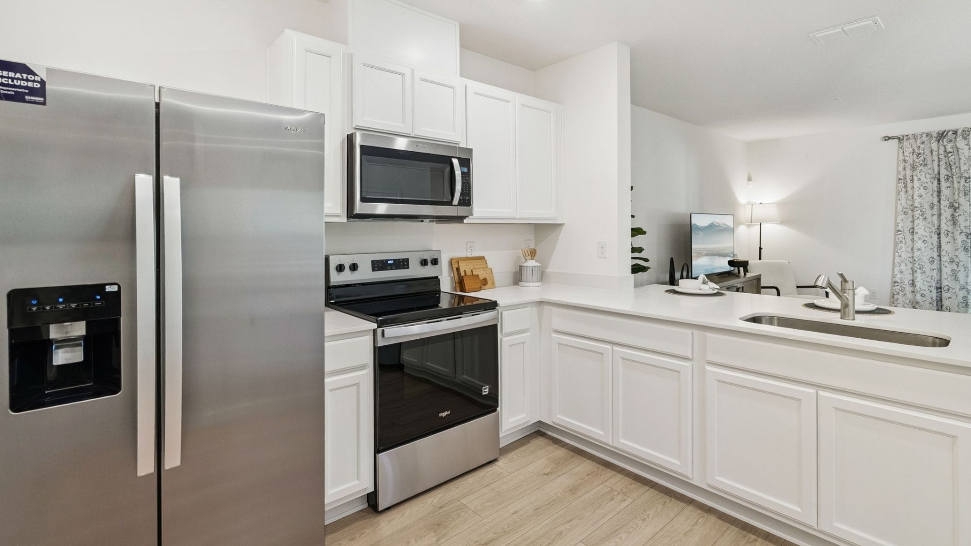kitchen with quartz countertops overseeing living area and dining room table