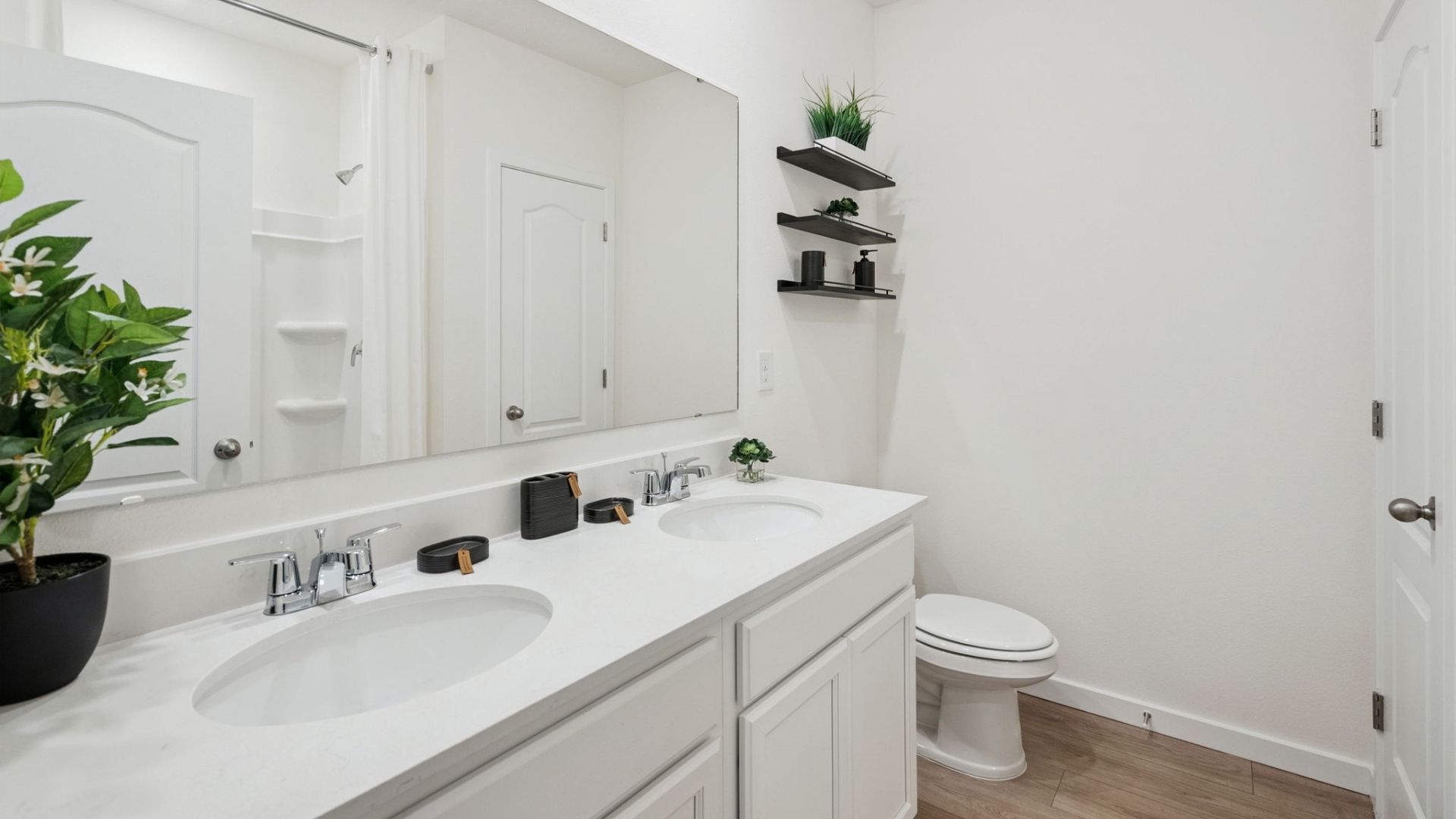 primary bathroom with quartz counters double sink and revwood select flooring