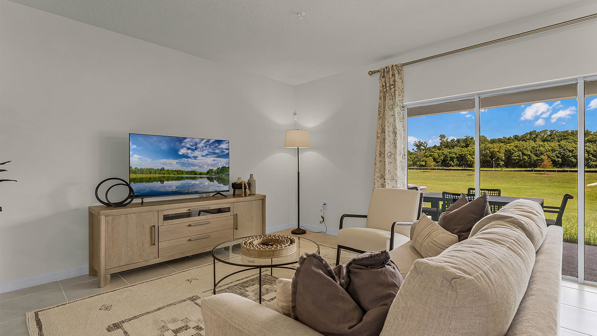 Living area with couch seating and access to backyard thru slidingdoor.