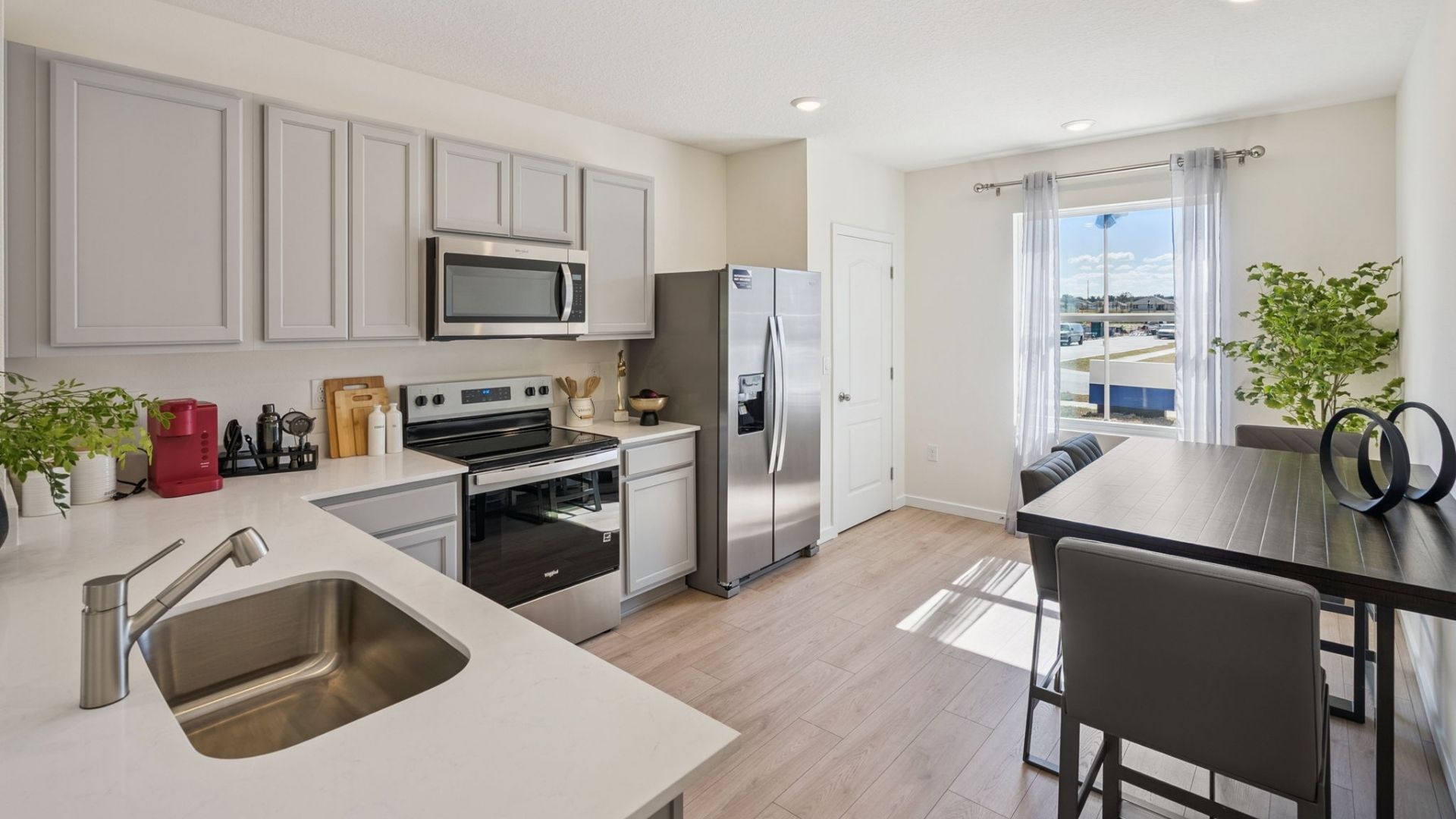 kitchen with quartz countertops overseeing living area and dining room table