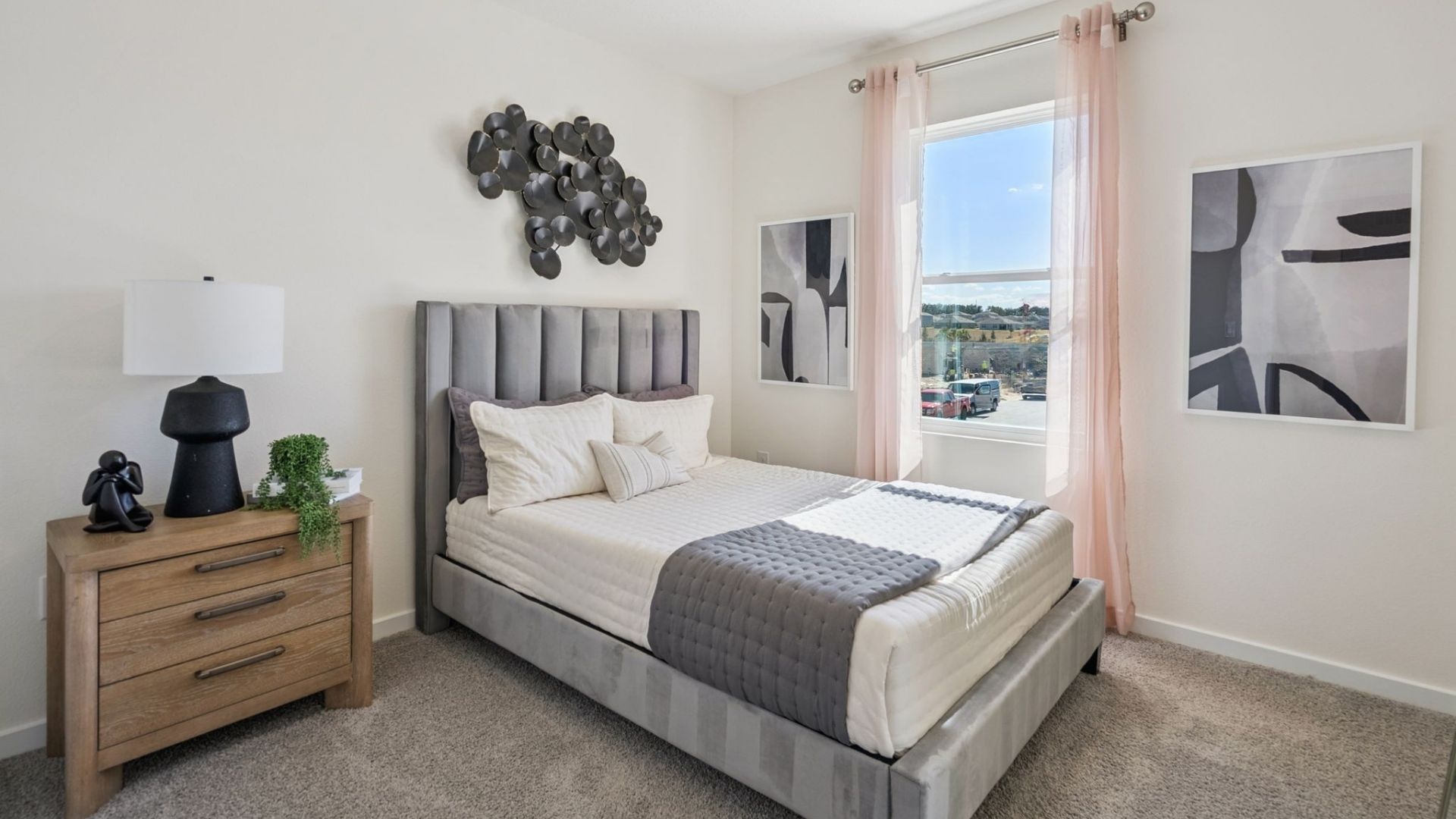 Guest bedroom with bed, nighstands and natural lighting.