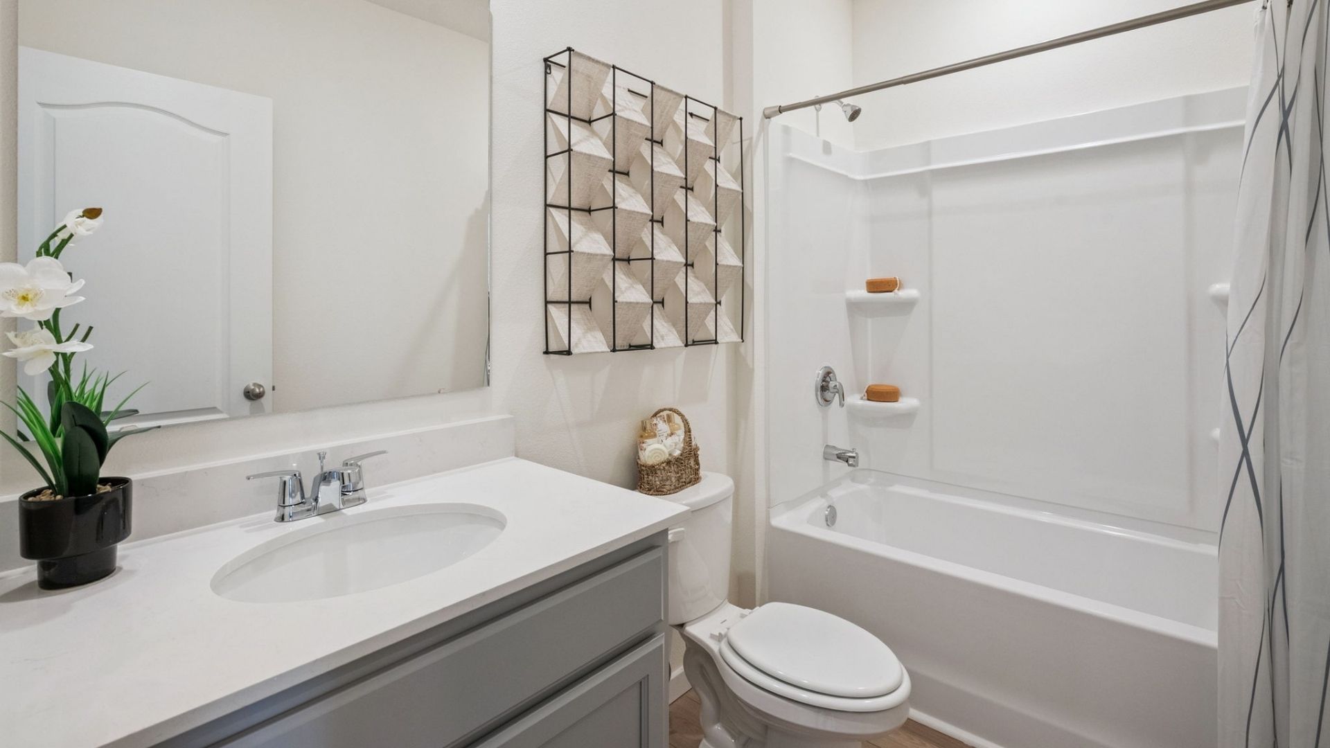 bathroom with quartz counters and revwood select flooring