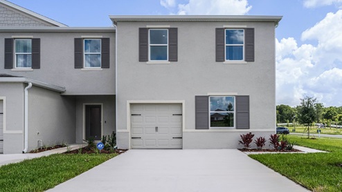 Attached townhome with concrete block construction and a one-car garage.