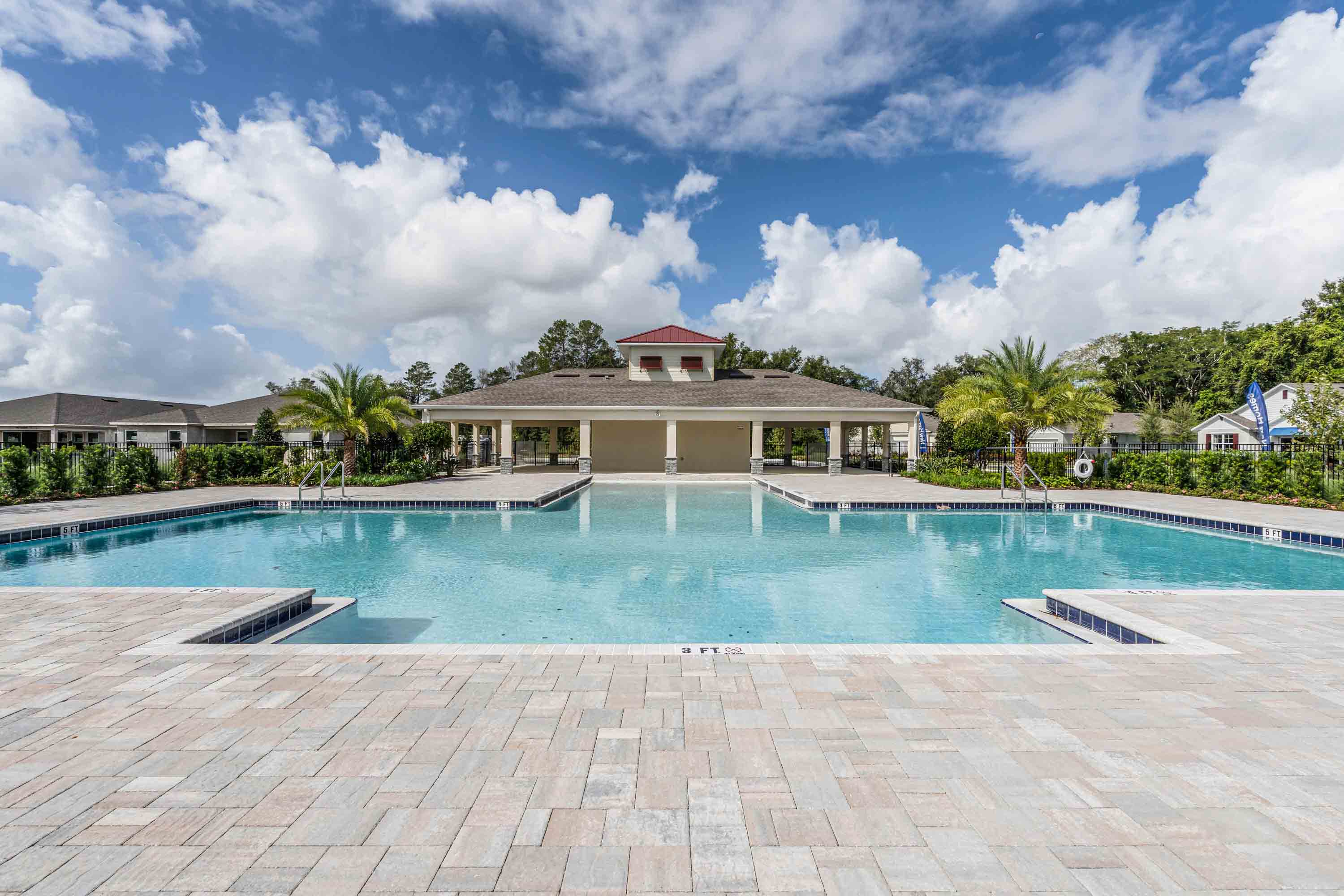 Sunny day at the community swimming pool with lounge seating.
