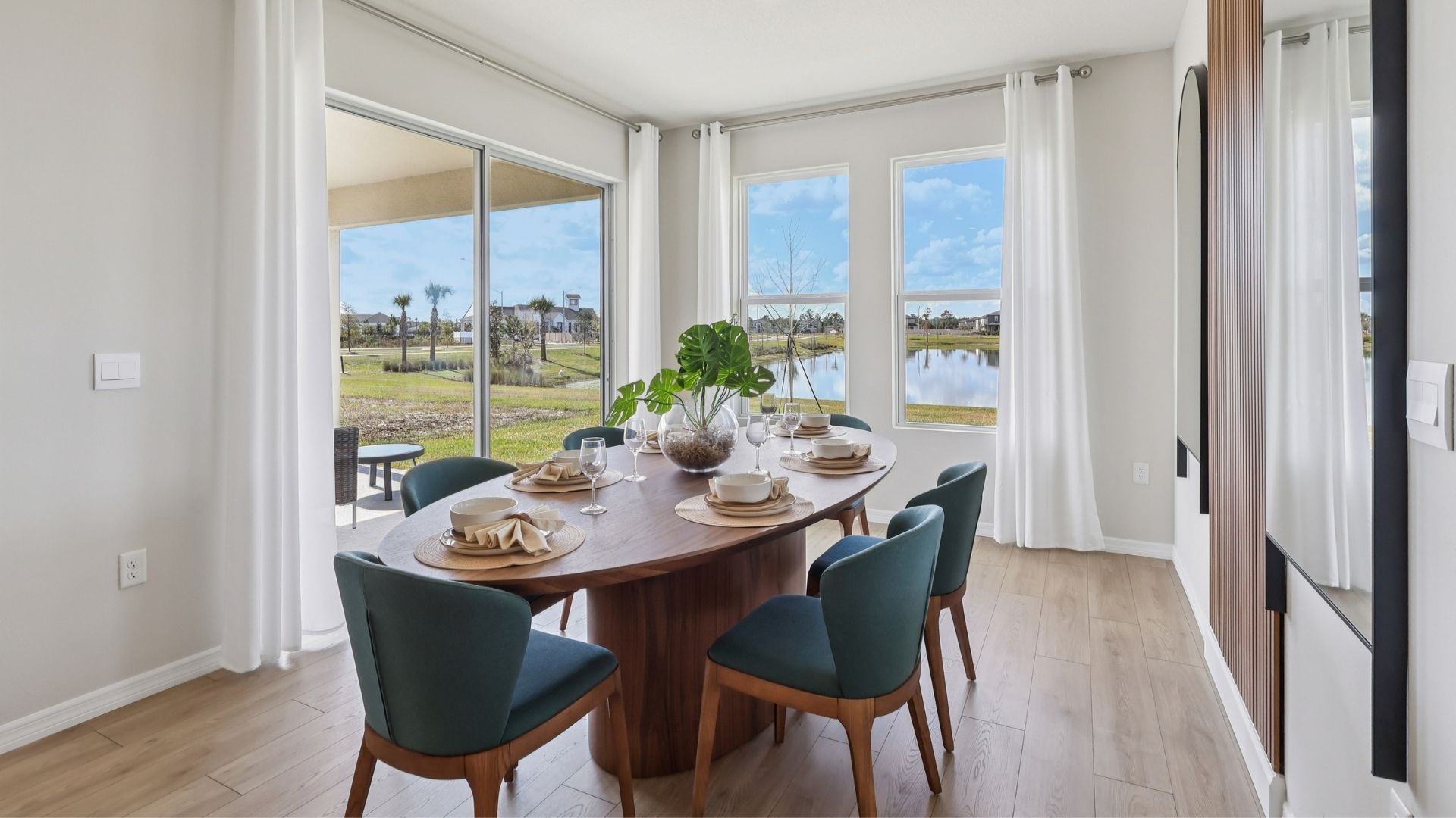 Dining room area with table, seating and natural lighting.