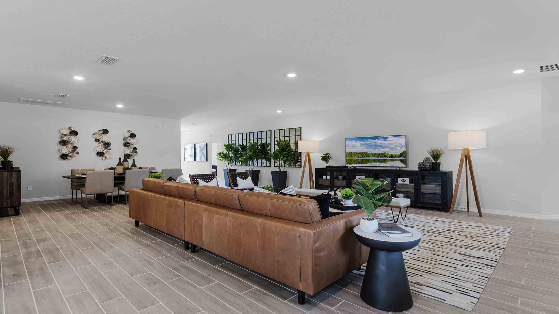 Living living area with couch seating and entertainment system adjacent to dining room.area overlooking masterbedroom